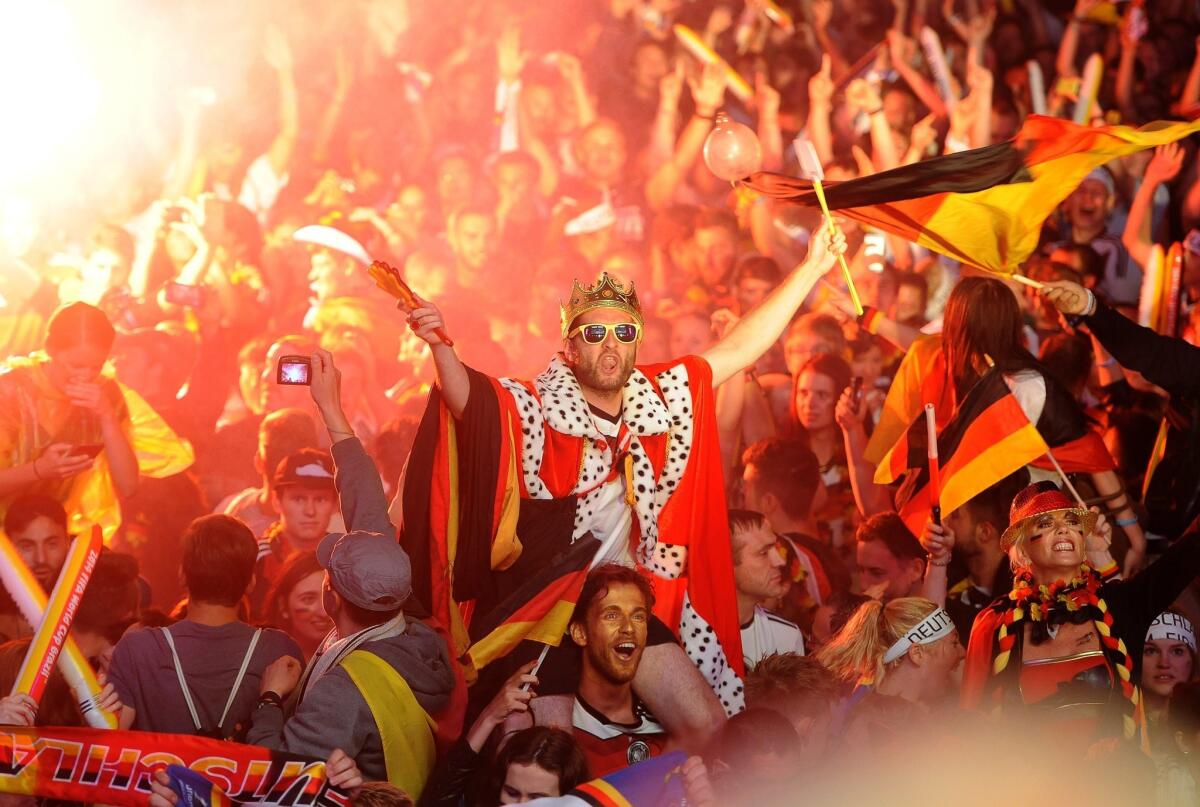 Germany fans in Berlin celebrate while watching the team's 1-0 victory over Argentina in the World Cup final.