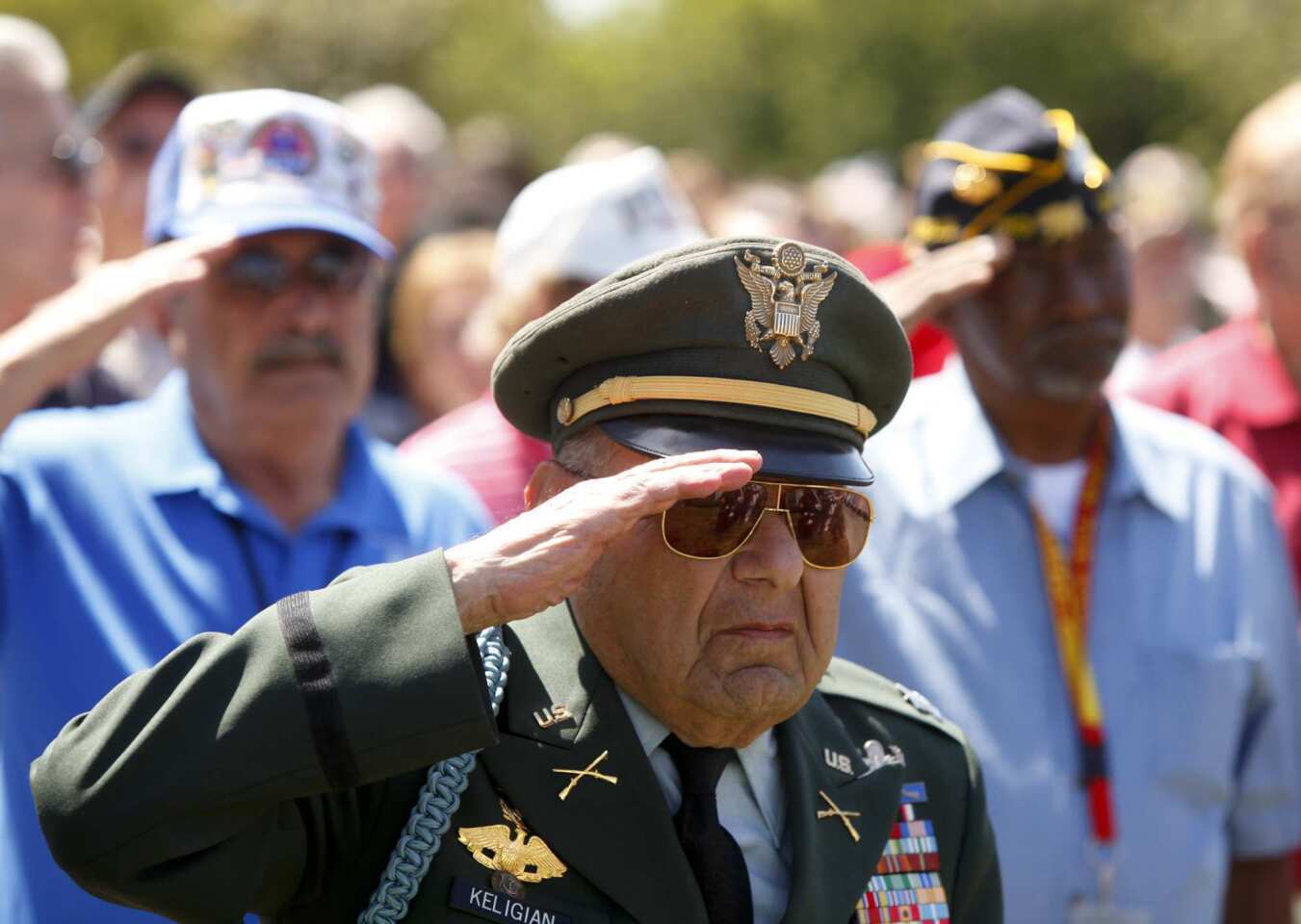 Retired Army Capt. Leo Keligian leads his fellow veterans in the salute to the flag during the Memorial Day observance at Los Angeles National Cemetery in Westwood.