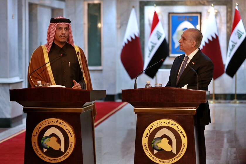 Iraqi Foreign Minister Mohamed Alhahkim, right, holds a press conference with visiting Qatari counterpart Sheikh Mohammed bin Abdulrahman Al Thani in Baghdad, Iraq, Wednesday, Jan. 15, 2020. (AP Photo/Khalid Mohammed)