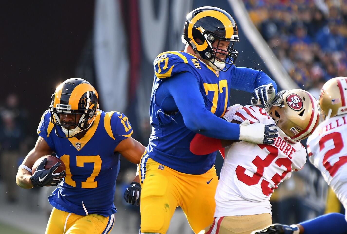 Rams tackle Andrew Whitworth provides a block for receiver Robert Woods as 49ers Tarvarius Moore is pushed back.