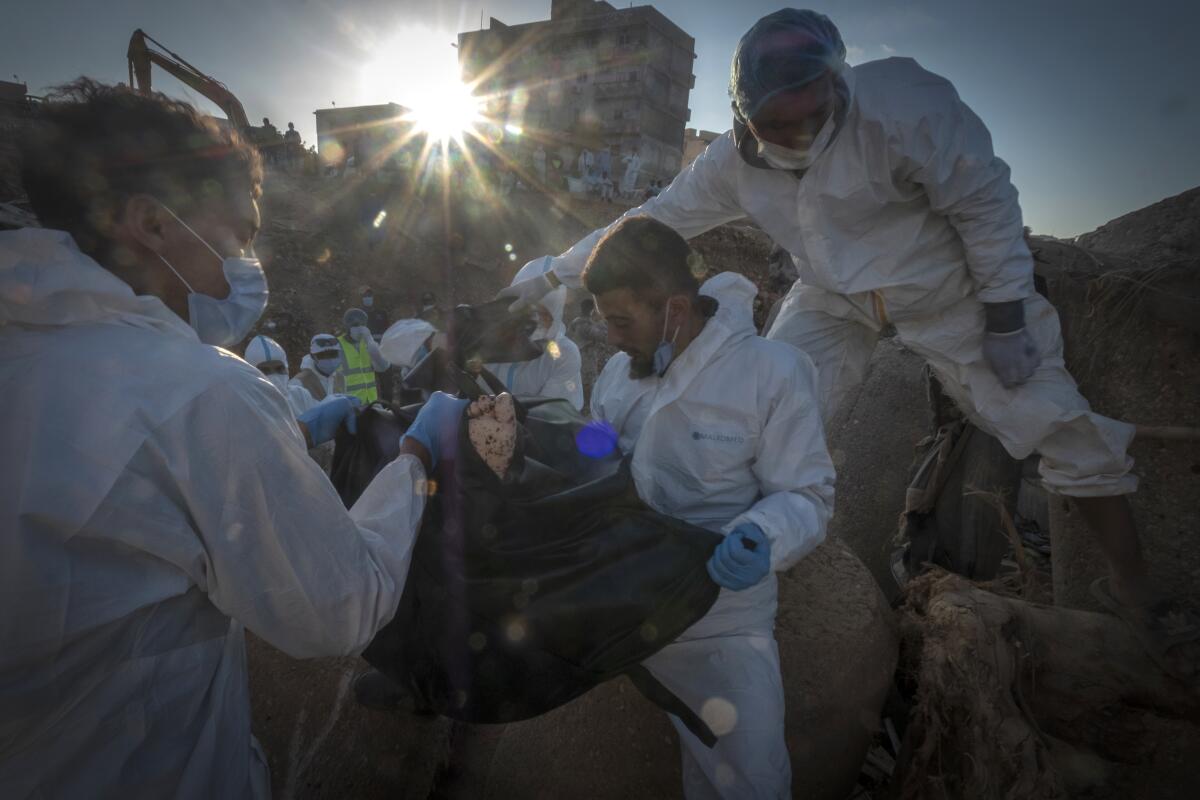 Rescuers recover the body of a flooding victim in Derna, Libya.
