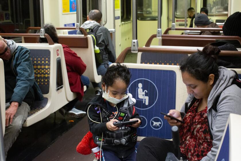 LOS ANGELES TIMES, -MARCH 19, 2020: Commuters ride the The Los Angeles Metro RailOs Metro D Line during the Covid-19 Pandemic in Los Angeles. (Gabriella Angotti-Jones/Los Angeles Times)