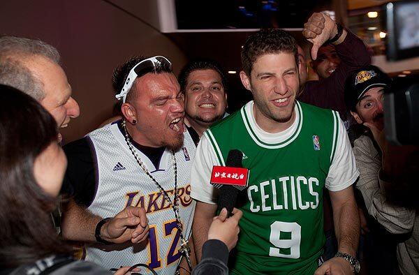Richard Cuevas, of Downey, (left) hassles Jon Salett, of Chicago, while trying to do a television interview after the Lakers defeated the Celtics in Game 6 of the NBA Finals held at the Staples Center on Tues., June 15, 2010, in Los Angeles.
