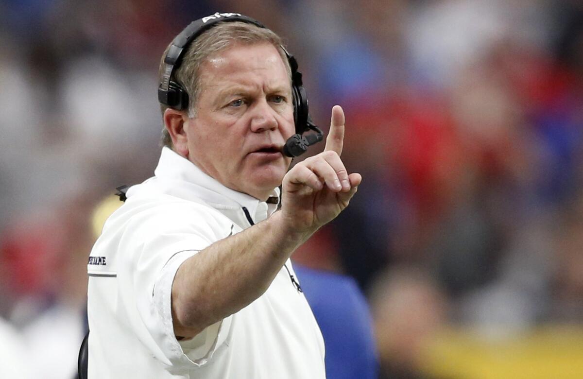 Notre Dame Coach Brian Kelly makes a call during the first half of the Fiesta Bowl against Ohio State on Jan. 1.