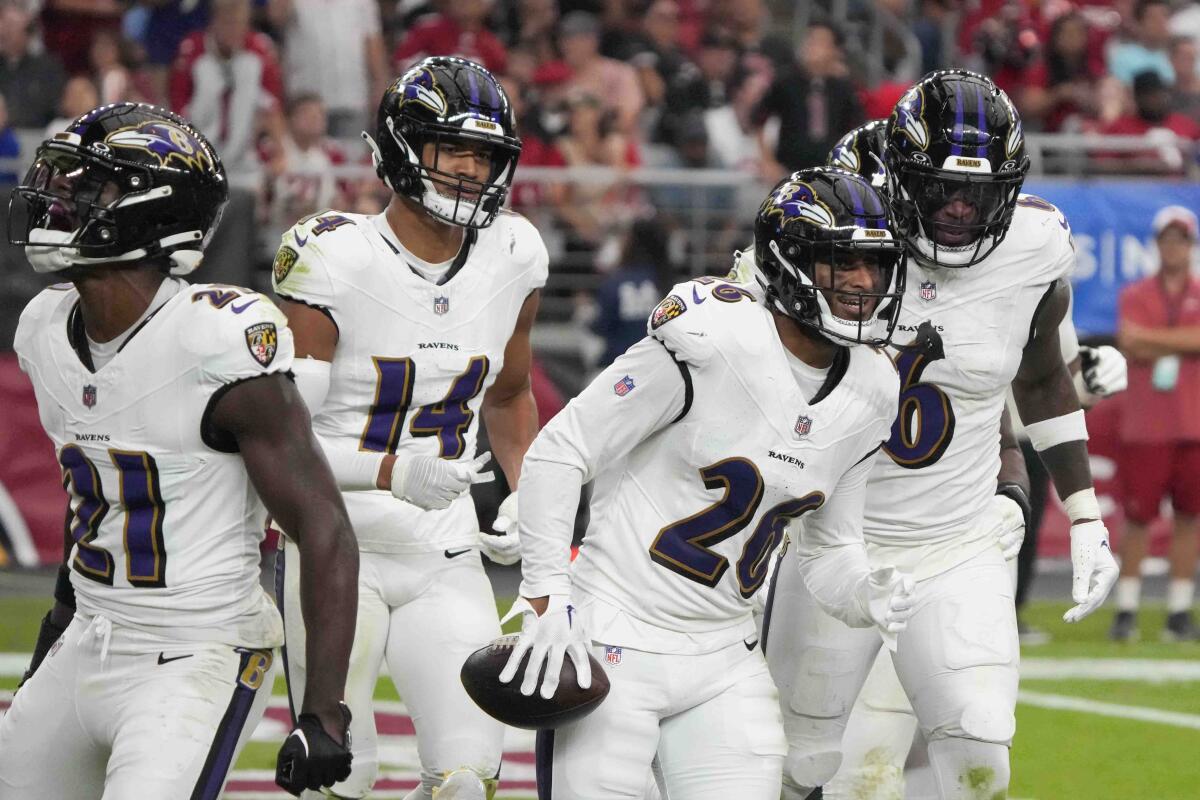 Ravens safety Geno Stone (26), celebrates his interception with teammates during a game against the Cardinals last season.