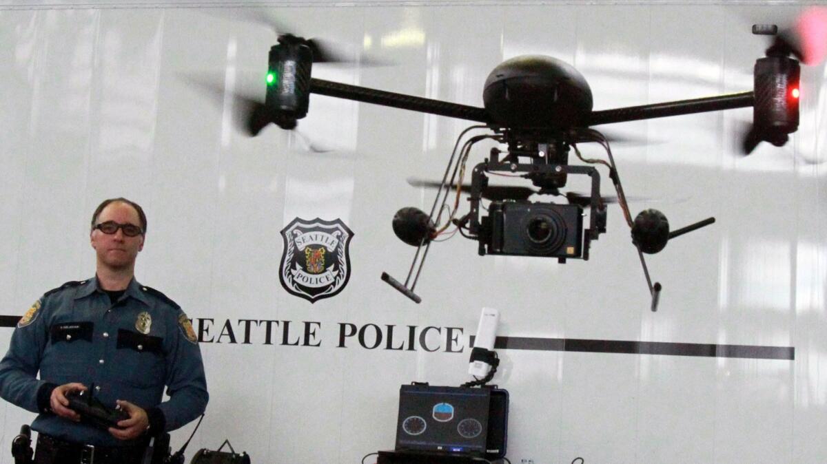 A Seattle police officer flies a drone in 2012. After public outcry, the Seattle Police Department grounded it drone initiative, giving the unmanned aircraft to the LAPD. The LAPD recently destroyed those devices but wants to test another model during a pilot program.