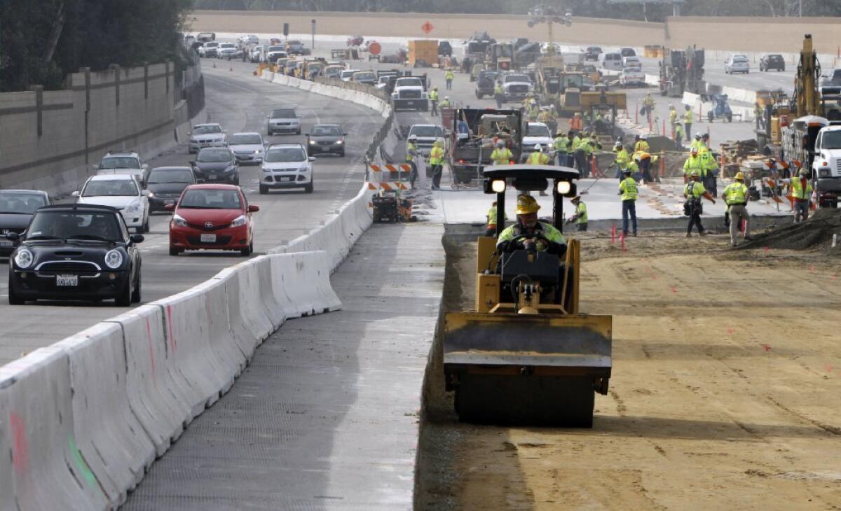 Workers are repaving northbound lanes of the 405 Freeway in the Sepulveda Pass. Three of five lanes are closed during the day.