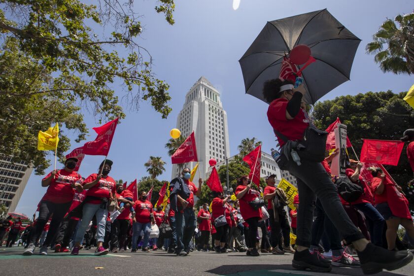 Los Angeles, CA - June 09: Fast-food workers lead a march to the state building on Spring Street after rally at Los Angeles City Hall to protest unsafe working conditions, and to demand a voice on the job through AB 257 Thursday June 8 2022 in Los Angeles. (Brian van der Brug/Los Angeles Times)