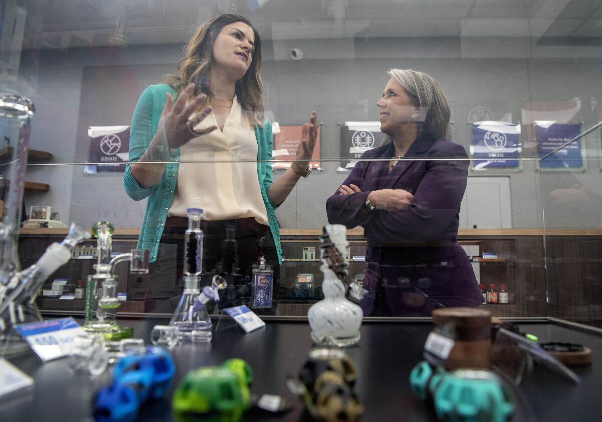 Gov. Michelle Lujan Grisham, right, takes a tour of the Everest Cannabis Co.-Uptown with CEO Trishelle Kirk on the first day of recreational cannabis sales, Friday April 1, 2022, Albuquerque. (Eddie Moore/The Albuquerque Journal via AP)