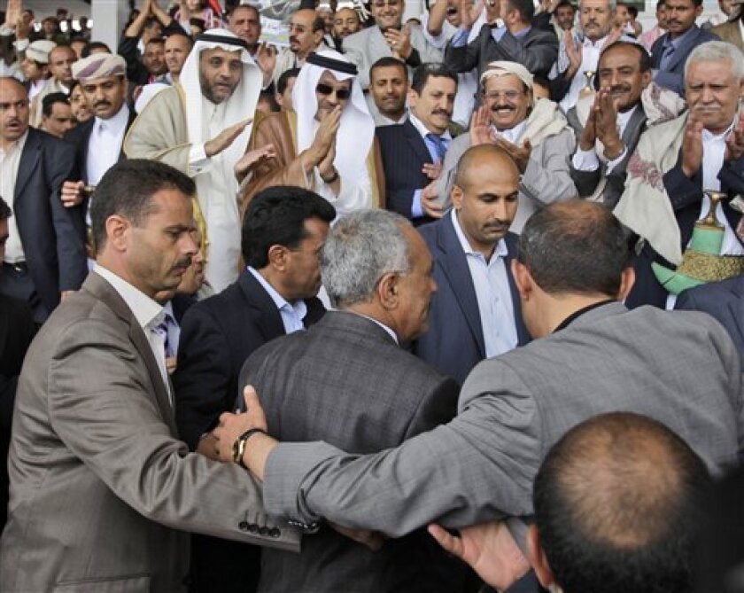 Yemeni President Ali Abdullah Saleh, center, surrounded by guards, walks toward his supporters during a rally in his support, in Sanaa,Yemen, Friday, May 6, 2011. (AP Photo/Hani Mohammed)