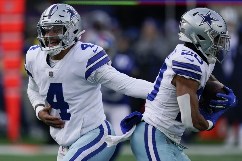 Dallas Cowboys quarterback Dak Prescott (4) hands off the ball to running back Tony Pollard (20) during the second quarter of an NFL football game, Sunday, Dec. 19, 2021, in East Rutherford, N.J. (AP Photo/Seth Wenig)