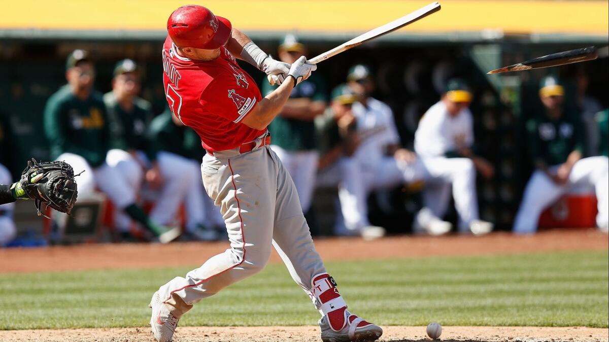 Mike Trout of the Angels breaks his bat in the ninth inning against the Oakland Athletics on Sunday.