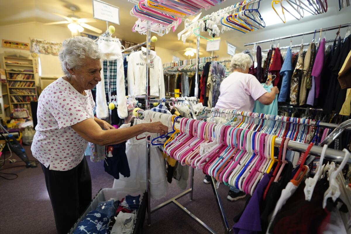 Lucy Thomas, 86, organizes the baby section inside the Mountain Empire Homemakers Assn. Thrift store. A longtime resident of the Campo area, she was not aware the town is for sale.