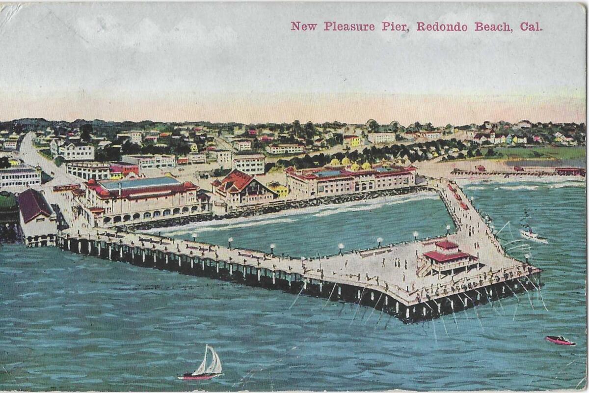 Aerial view of Redondo Beach's "New Pleasure Pier," with boats on the waves and fishing lines from the deck into the water.