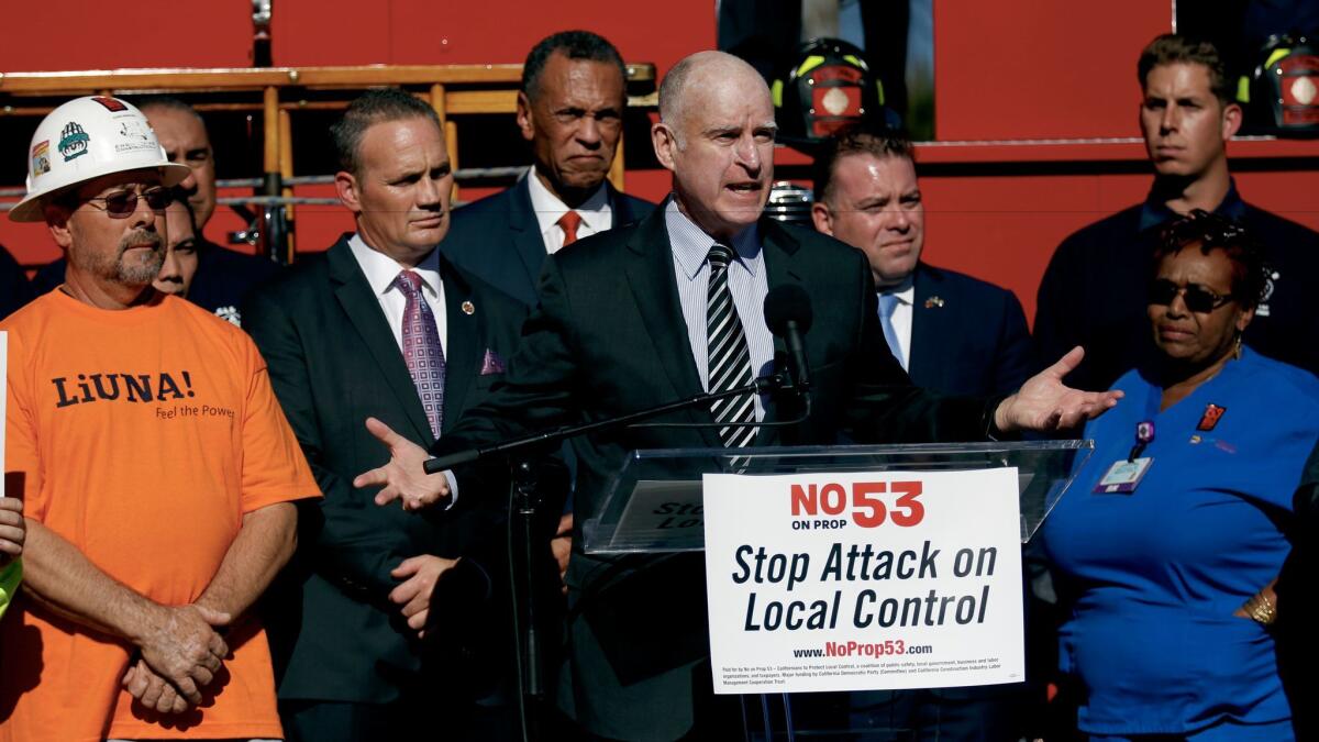 Gov. Jerry Brown speaks during a press conference opposing Prop 53 at the United Firefighters Headquarters in Los Angeles.