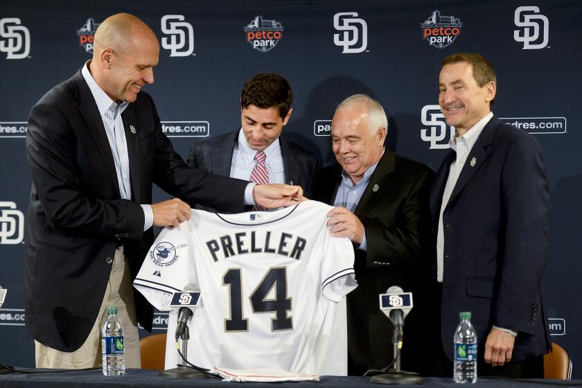 SAN DIEGO, CA - AUGUST 6: President & Chief Executive Officer Mike Dee, Executive Chairman Ron Fowler and Peter Seidler of the San Diego Padres present A.J. Preller with a San Diego Padres jersey as he is named the new General Manager of the San Diego Padres at a press conference at Petco Park on August 6, 2014 in San Diego, California. (Photo by Andy Hayt/San Diego Padres/Getty Images) *** LOCAL CAPTION *** A.J. Preller;Mike Dee;Ron Fowler;Peter Seidler