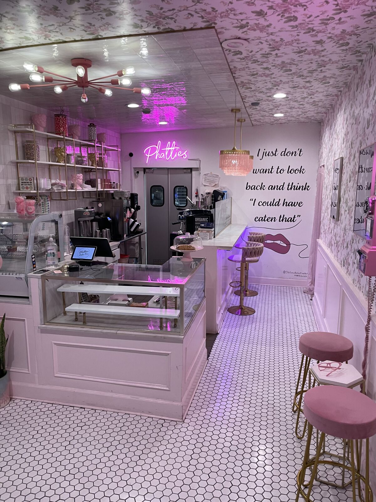 The interior of Phatties Bake Shop is big on pink, including the tasseled Sputnik chandeliers.