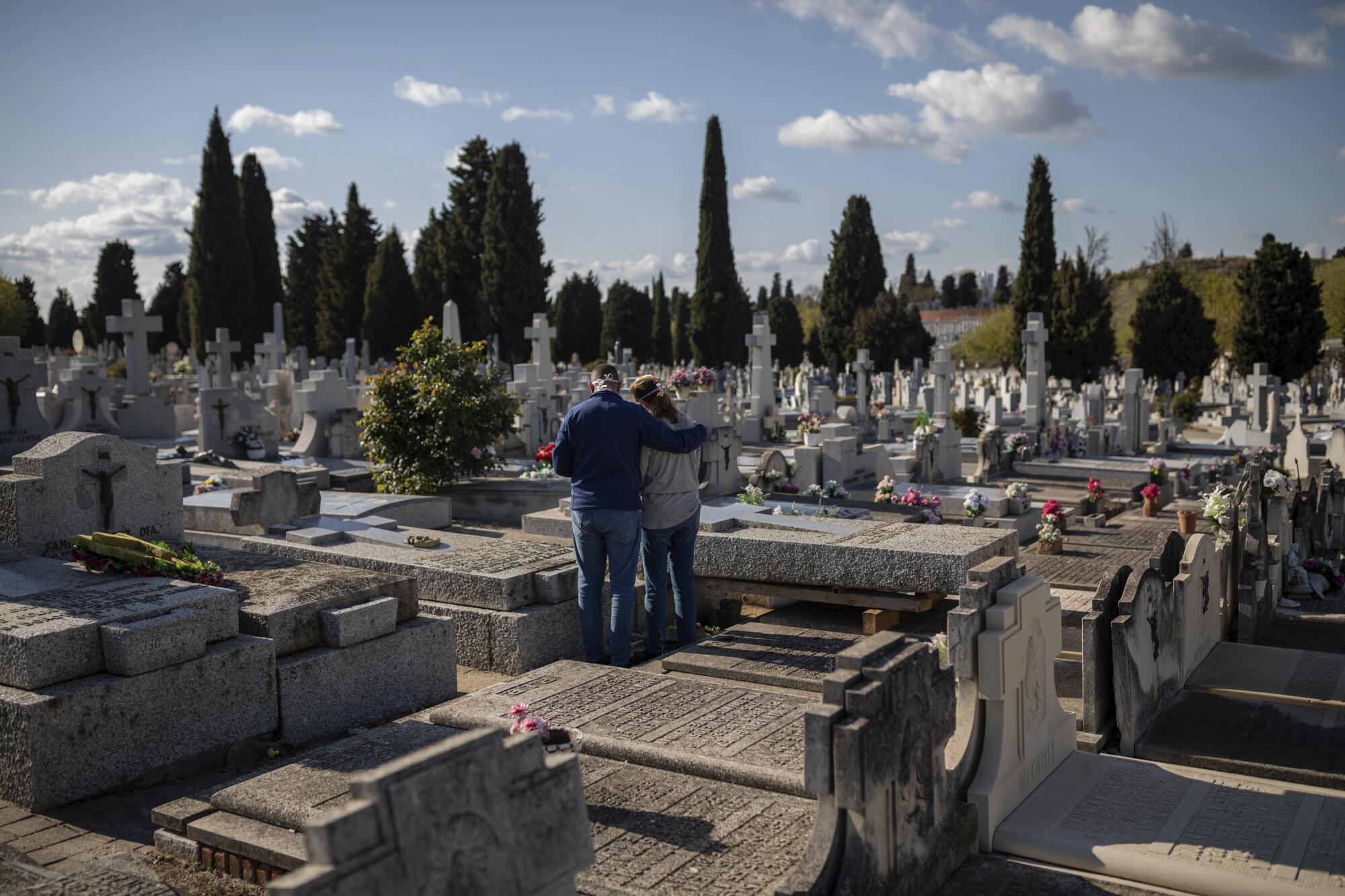 SPAIN: Two people at a Madrid cemetery.
