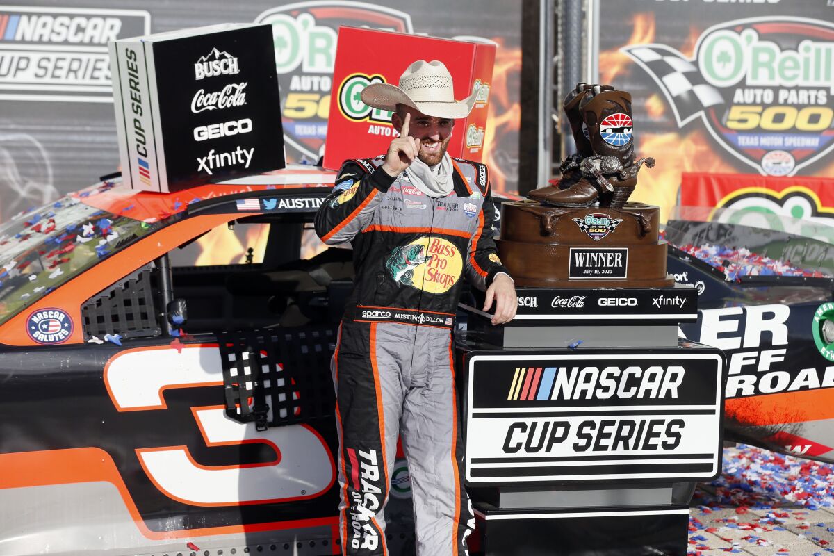 Austin Dillon gestures in Victory Lane after winning the NASCAR Cup Series auto race at Texas Motor Speedway.