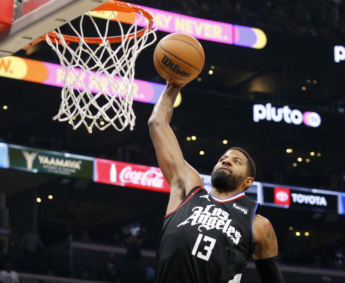 Clippers forward Paul George throws down a dunk against the Detroit Pistons.