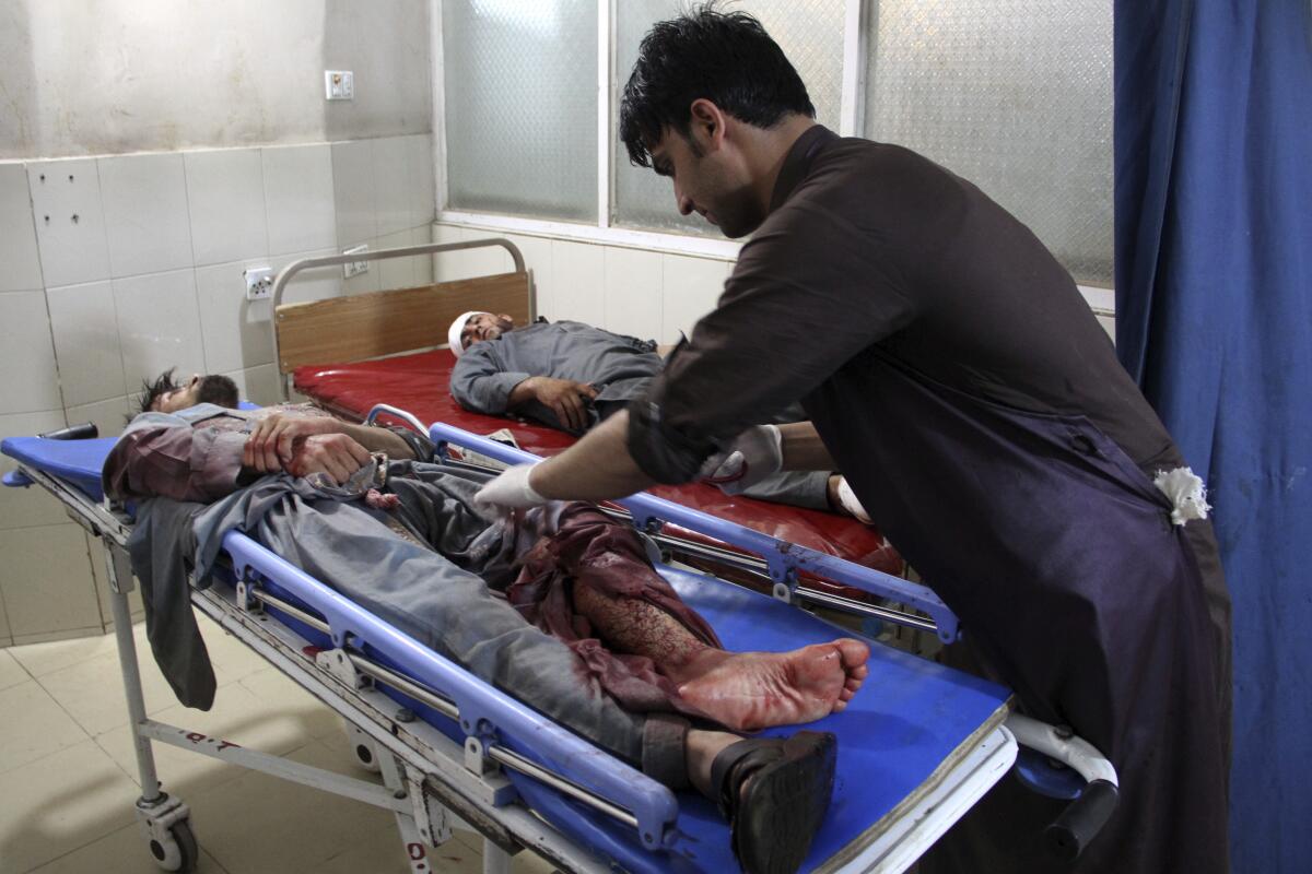 A wounded man is treated at a hospital Sunday after a suicide car bomb and gun battle in Afghanistan's Nangarhar province.