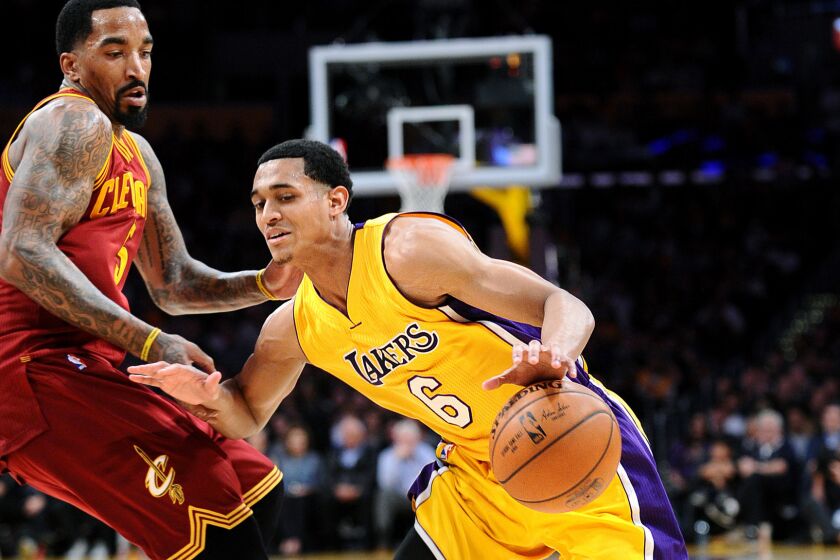 Lakers guard Jordan Clarkson tries to drive past Cavaliers guard J.R. Smith during a game last season.