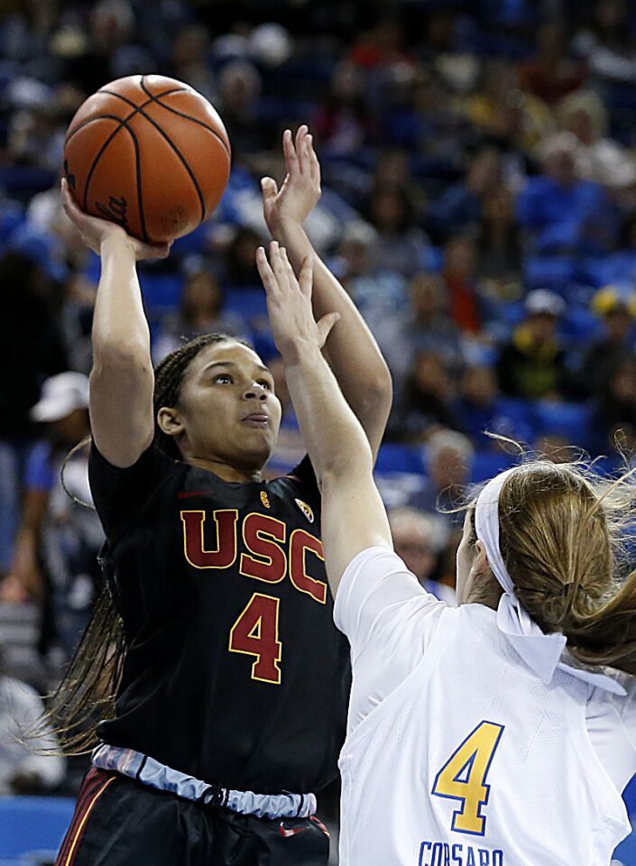 USC guard Endyia Rogers (4) shoots over UCLA guard Lindsey Corsaro during the first half.