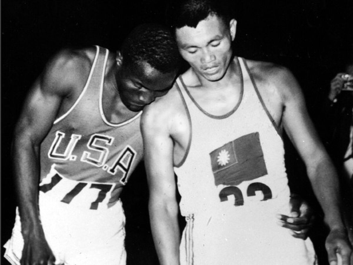 Rafer Johnson puts his head on the shoulder of UCLA teammate and training partner C.K. Yang.