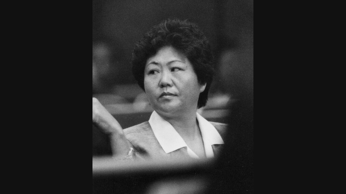 A woman sits in a courtroom