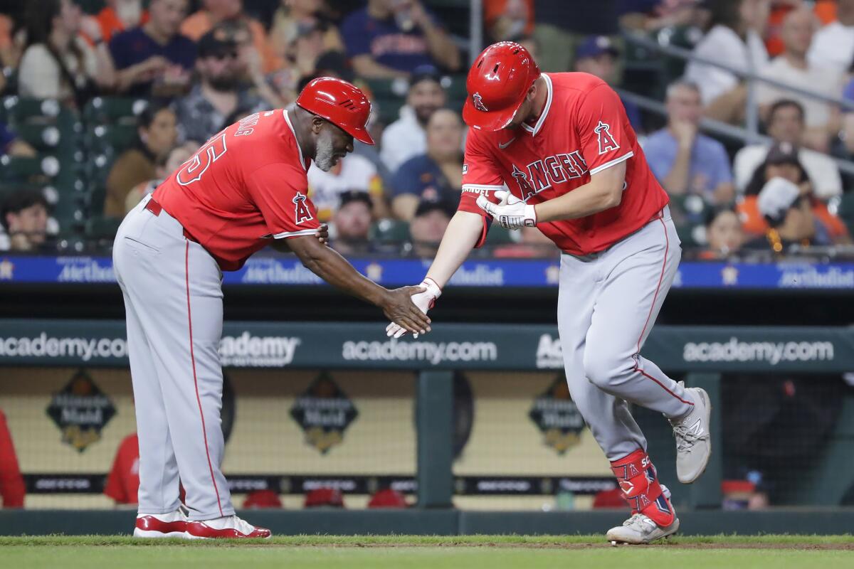 The Angels' Nolan Schanuel greets third base coach Eric Young Sr. after his three-run homer in the fifth inning