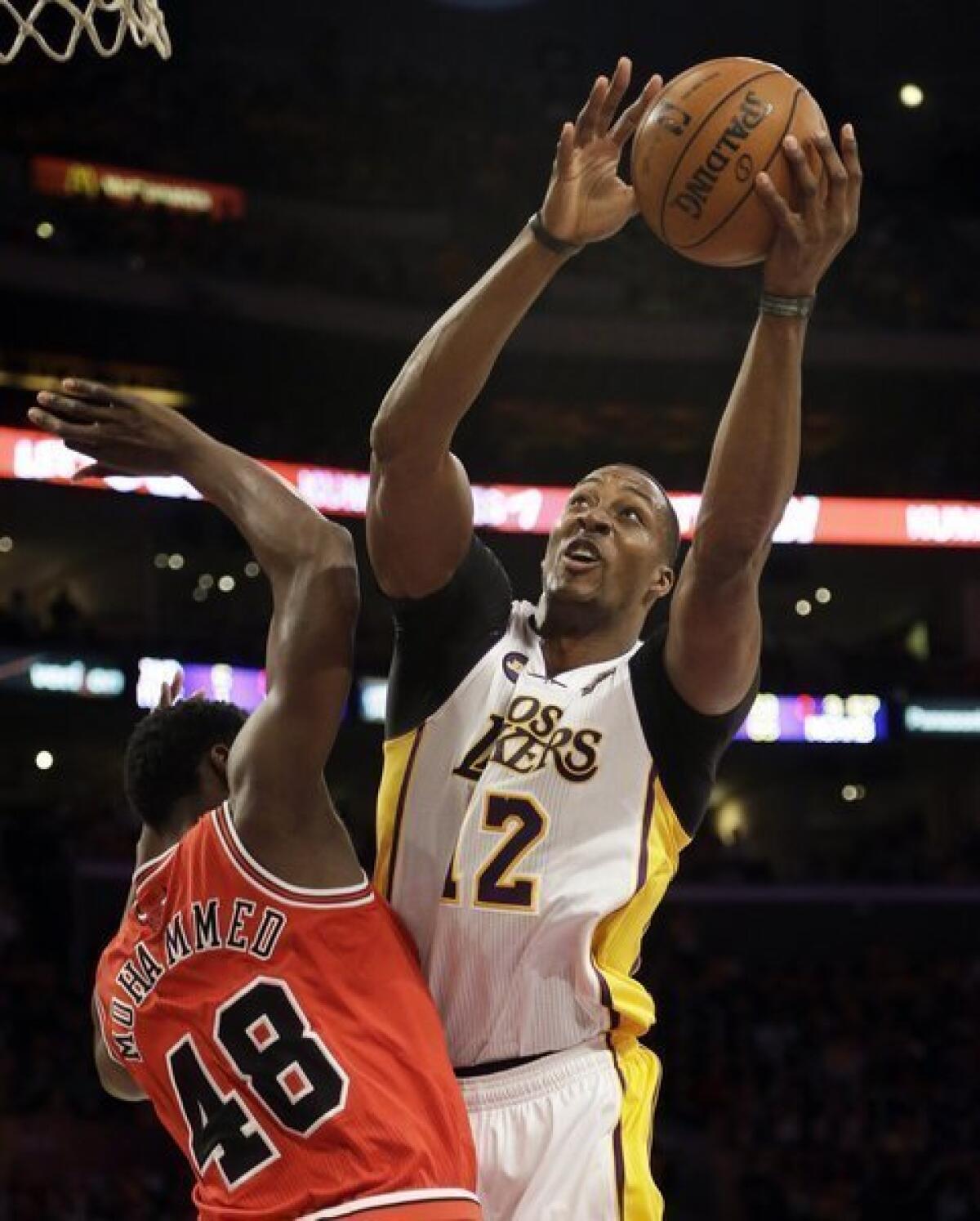 Lakers center Dwight Howard powers his way to the basket against Bulls power forward Nazr Mohammed.