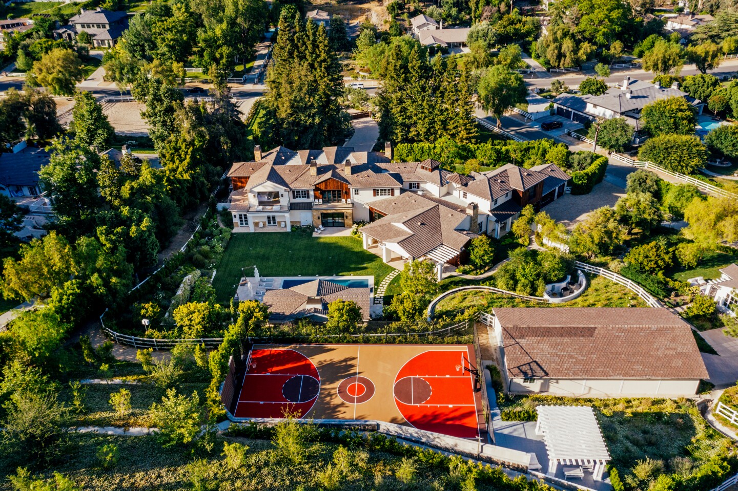 Tesfaye, better known by his stage name The Weeknd, listed his massive estate in Hidden Hills for sale at $24.995 million. Redwood trees frame the front of the farmhouse-style mansion, which has nine bedrooms and 11 bathrooms plus a detached guesthouse. Features of the home include an eye-catching wine cellar, multiple bars and seven fireplaces. A basketball court sits at the far end of the the-acre property.