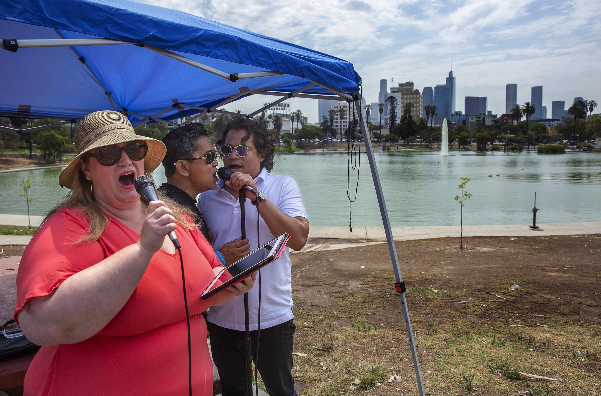 Professional opera singers Christina Stevens, Eli Zari, and Marco Antonio White perform at MacArthur Park in L.A.