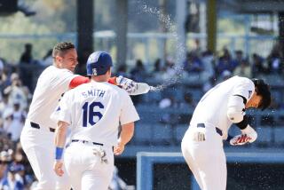 LOS ANGELES, CA - MAY 19: Dodgers Miguel Rojas, left, throws water on designated hitter Shohei Ohtani, right, after a walk off RBI single in the tenth inning at Dodger Stadium on Sunday, May 19, 2024 in Los Angeles, CA. (Gina Ferazzi / Los Angeles Times)