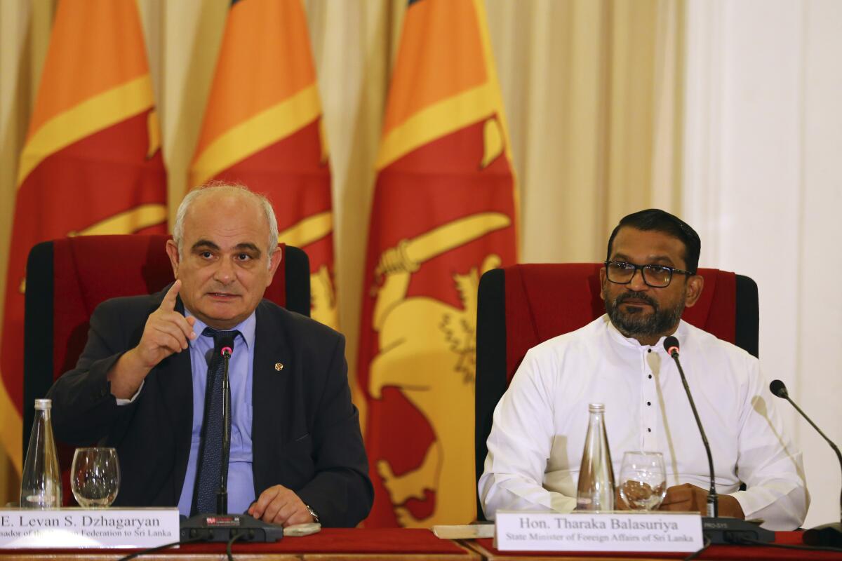Russian Ambassador to Sri Lanka, Levan S. Dzhagaryan, left, speaks sitting next to Hon. Tharaka Balasuriya, State Minister of Foreign Affairs of Sri Lanka, at a press conference in Colombo, Sri Lanka, Thursday, May 30, 2024. (AP Photo)