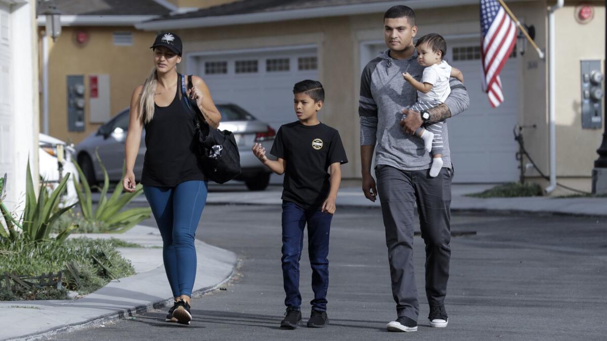 Alicia and Bryan Espinoza with their children, Bryan Jr., 9, and Nicholas, 11 months, at the development in Santa Clarita where they are buying a home.
