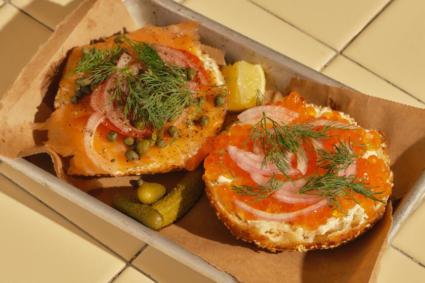 LOS ANGELES , CA - OCTOBER 10: The hand-sliced smoked salmon bagel (left) and roe-topped bagel at Courage Bagels on Monday, Oct. 10, 2022 in Los Angeles , CA. (Shelby Moore / For The Times)
