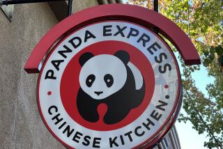 Close-up of a red, black, and white 'Panda Express Chinese Kitchen' restaurant sign