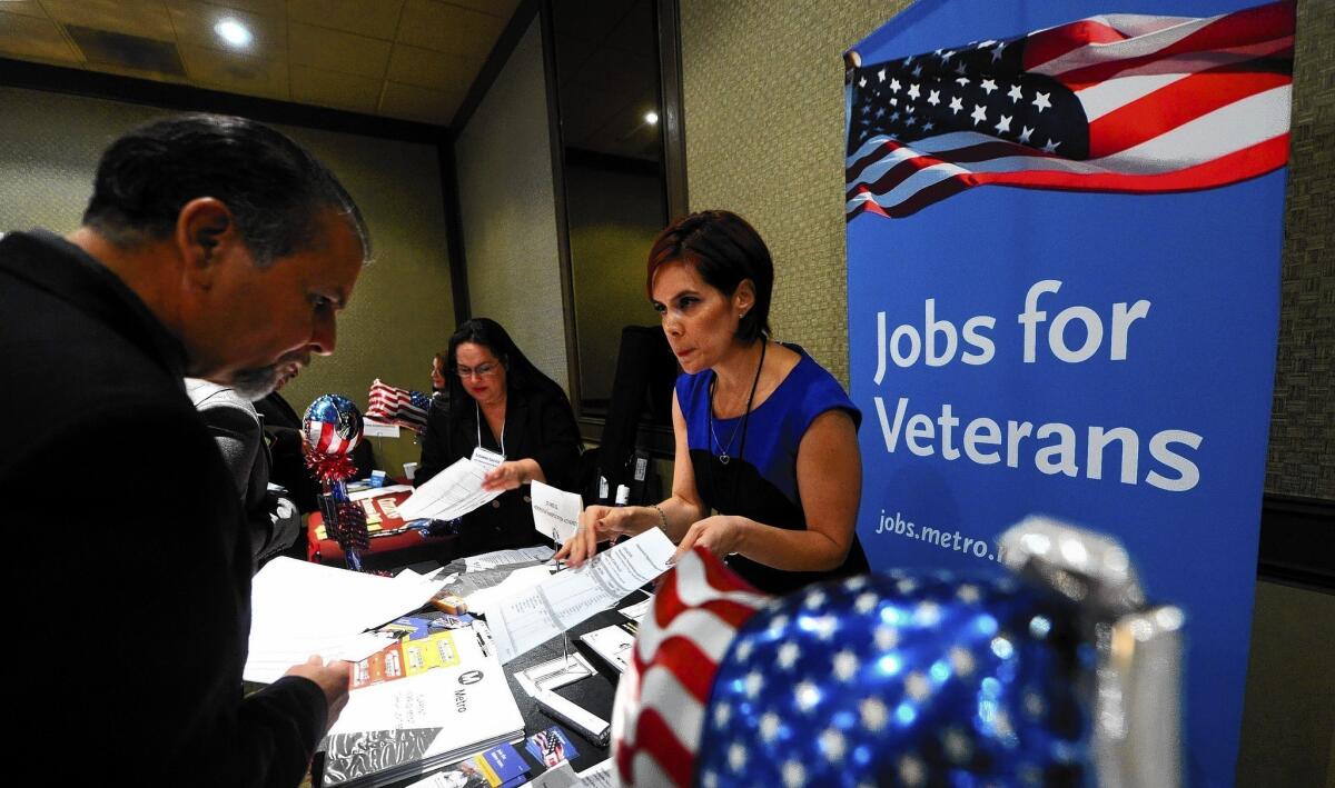 The government said U.S. employers added a meager 74,000 new jobs last month, the smallest in almost three years. Above, job seekers attend a career fair in Van Nuys last year.