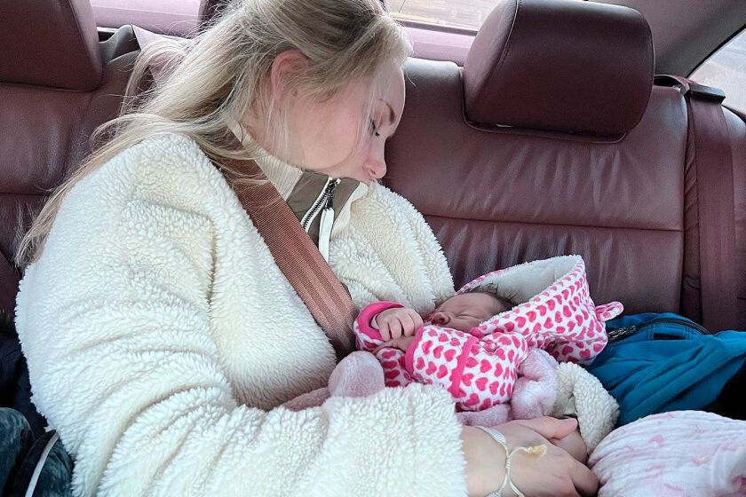 Jessie Boeckmann, of Costa Mesa, escaped from Ukraine to Poland on Friday with their newborn daughter after braving a crush of refugees at the border as they fled the Russian invasion.