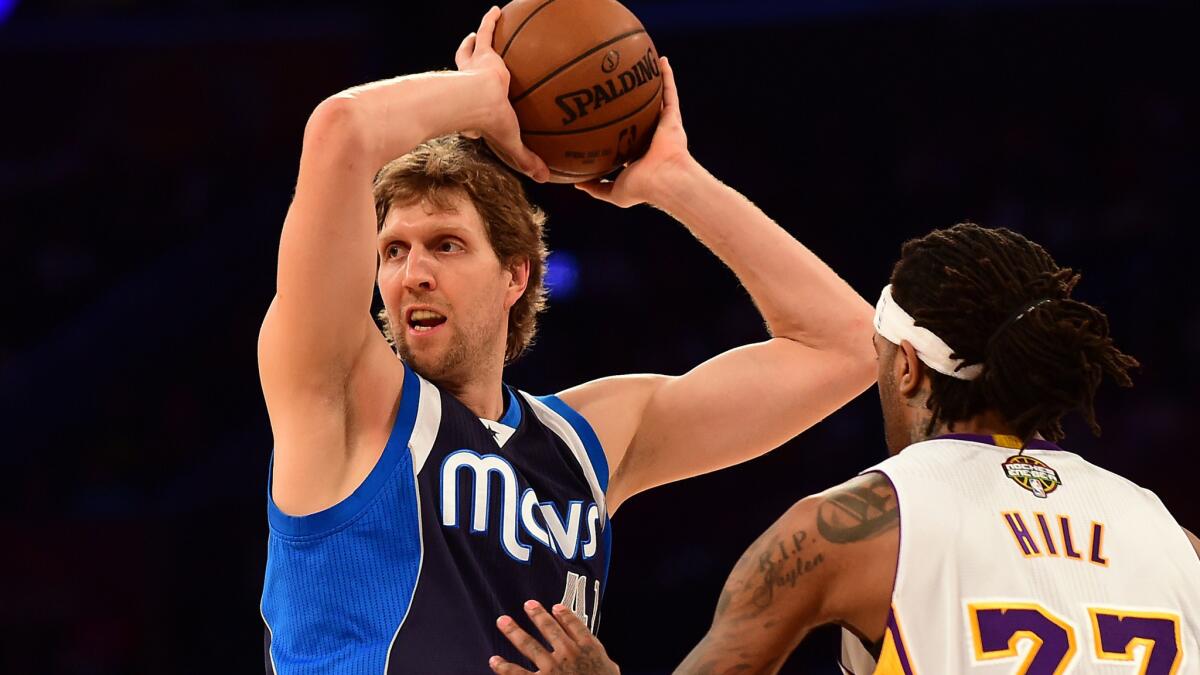 Dallas Mavericks center Dirk Nowitzki looks to pass in front of Lakers forward Jordan Hill during a game at Staples Center on March 8.