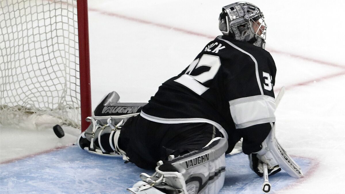 The puck squirts past Kings goalie Jonathan Quick for a second period goal from Golden Knights defenseman Brayden McNabb.