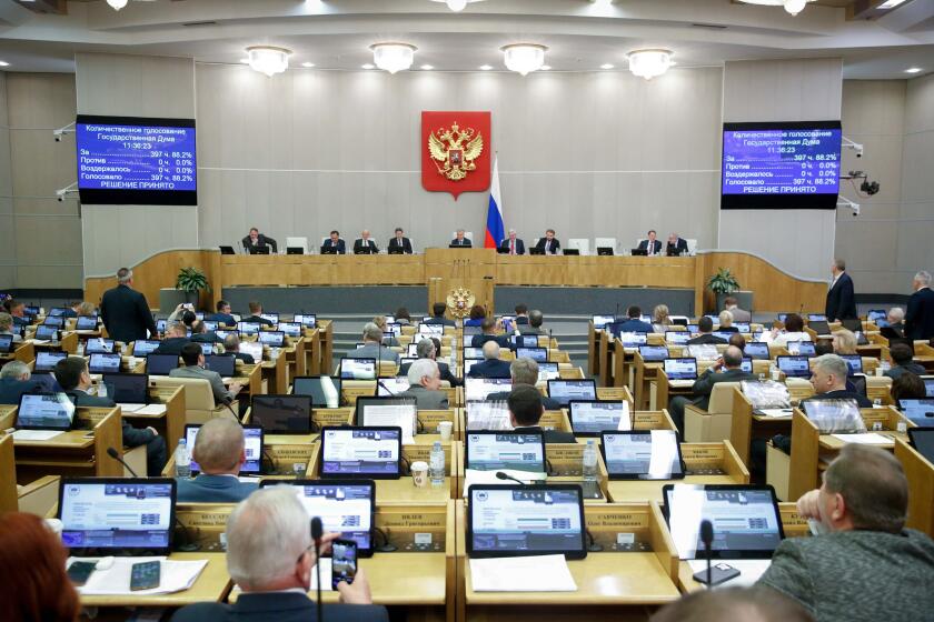 In this handout photo provided by The State Duma, The Federal Assembly of The Russian Federation, Russian lawmakers attend a session of the State Duma, the Lower House of the Russian Parliament in Moscow, Russia, Thursday, Nov. 24, 2022. Russian lawmakers have given their final approval to a bill that significantly expands restrictions on activities seen as promoting LGBTQ rights in the country. (The State Duma, The Federal Assembly of The Russian Federation via AP)