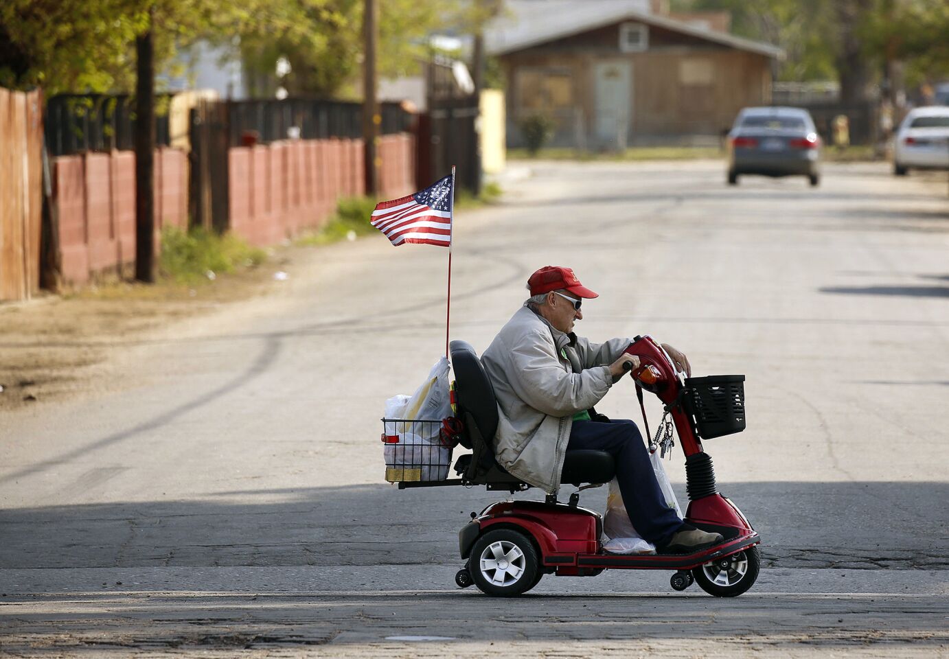 Leonard McGill, 73, proudly flies the American flag from his scooter while riding through Oildale, an unincorporated community in Kern County.
