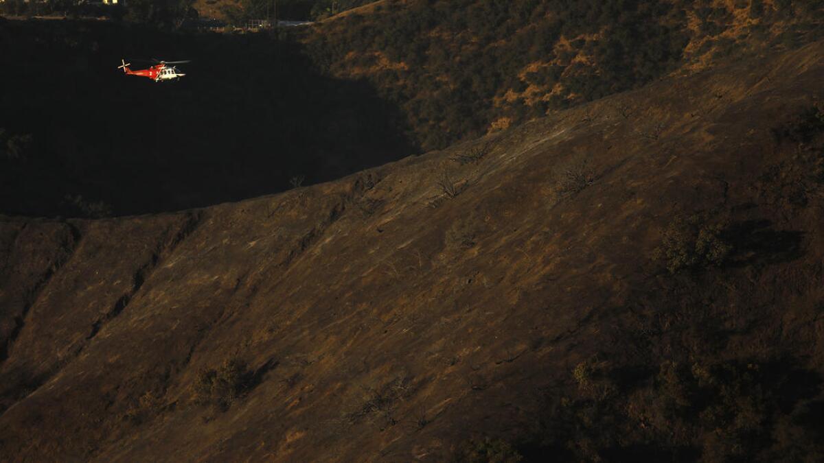 A helicopter scouts for hot spots from the Skirball fire in Bel-Air.