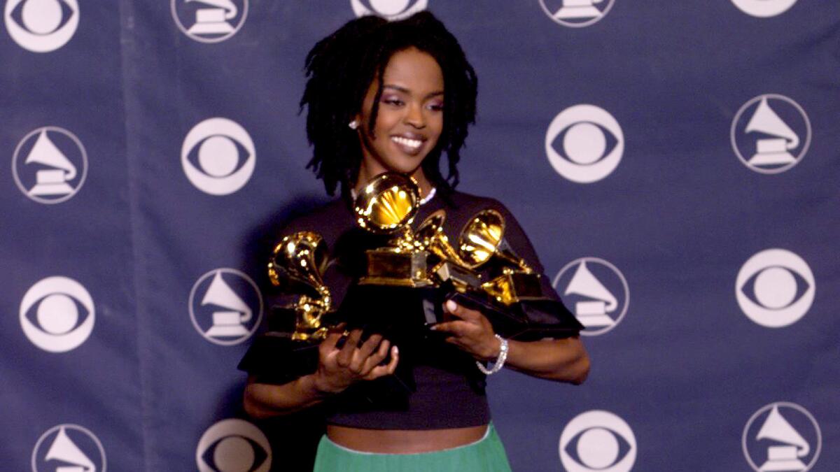 Lauryn Hill holds her five Grammys.