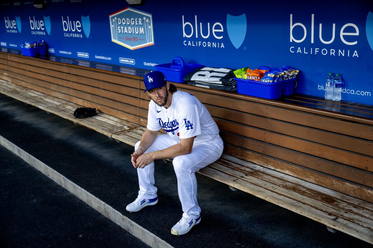 Clayton Kershaw sits alone in the dugout before a 7-0 win over the San Francisco Giants at Dodger Stadium.
