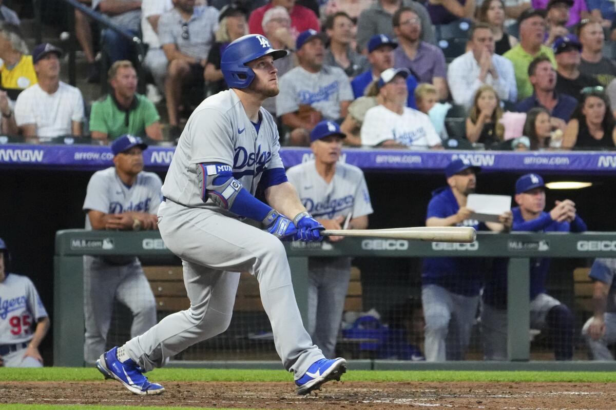 Dodgers batter Max Muncy watches his home run ball hit off Colorado pitcher Kyle Freehand on Tuesday.