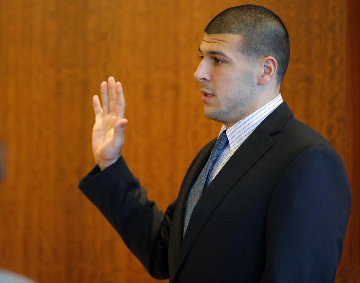 Aaron Hernandez, former player for the NFL's New England Patriots football team, takes an oath to tell the truth before being questioned by Judge Susan Garsh during a court appearance at the Bristol County Superior Court in Fall River, Massachusetts October 9, 2013, in connection with the death of semi-pro football player Odin Lloyd in June. Hernandez, who was a rising star in the NFL before his arrest and release by the Patriots, has pleaded not guilty.