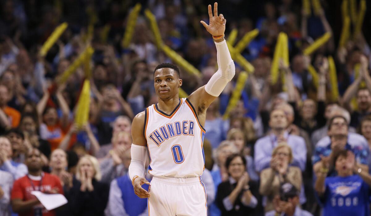 Thunder guard Russell Westbrook (0) waves to the crowd after tying the record for triple-doubles in a season during a game against the Milwaukee Bucks in Oklahoma City on April 4.